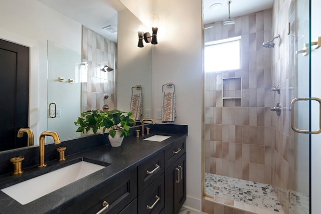 bathroom with double sink vanity and walk in shower