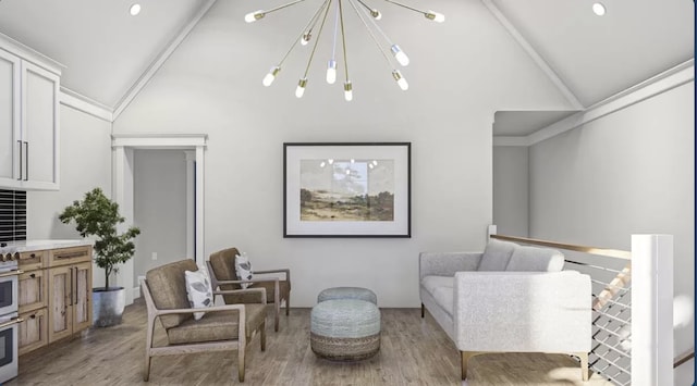 sitting room with a chandelier, high vaulted ceiling, and wood-type flooring