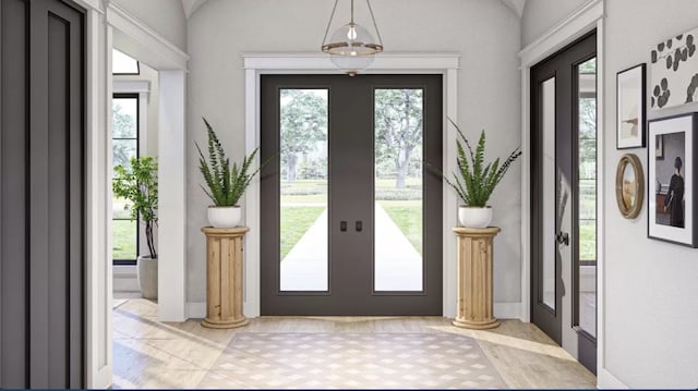 foyer entrance featuring decorative columns and french doors