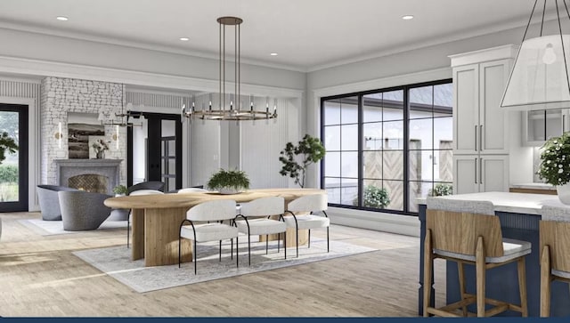 dining room with light hardwood / wood-style floors, ornamental molding, plenty of natural light, and a chandelier