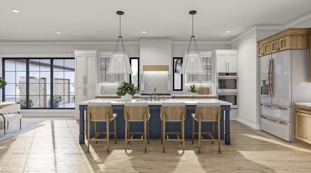 kitchen with an island with sink, light wood-type flooring, tasteful backsplash, and appliances with stainless steel finishes