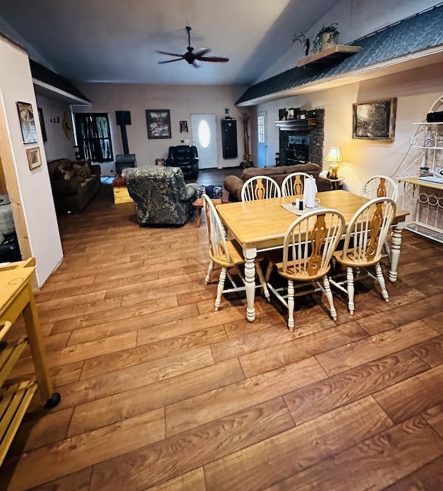 dining room featuring vaulted ceiling, hardwood / wood-style floors, and ceiling fan