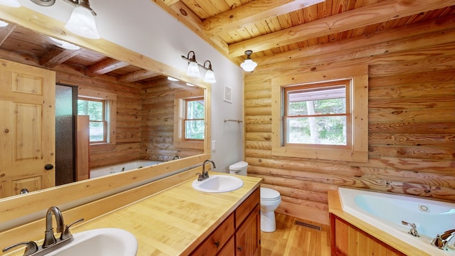 bathroom with a bathing tub, toilet, hardwood / wood-style floors, beamed ceiling, and log walls