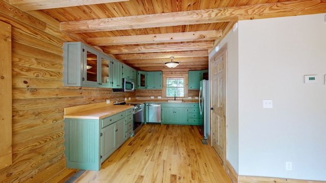 kitchen with light hardwood / wood-style flooring, beamed ceiling, stainless steel appliances, rustic walls, and wood ceiling