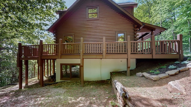 back of property with a wooden deck