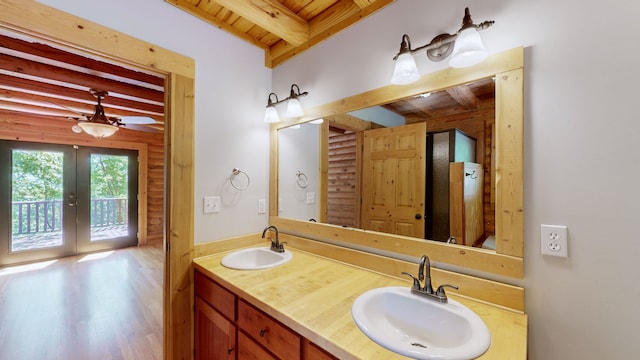 bathroom featuring french doors, dual vanity, beamed ceiling, wood ceiling, and wood-type flooring