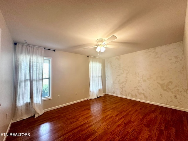 spare room with ceiling fan and wood-type flooring