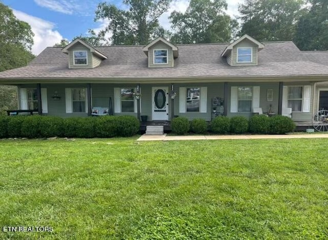 cape cod-style house with a front lawn and covered porch