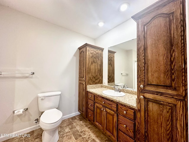 bathroom with tile patterned floors, vanity, and toilet