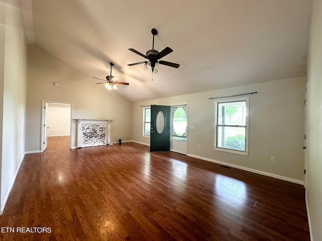 unfurnished living room with vaulted ceiling, dark wood-type flooring, and ceiling fan