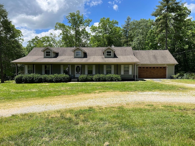 new england style home featuring a front lawn and a garage