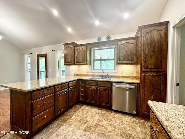 kitchen with sink, light stone counters, light tile patterned floors, and stainless steel dishwasher