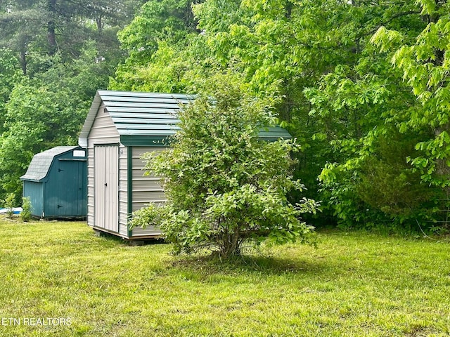 view of outbuilding featuring a yard