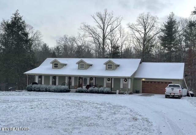 view of front of house featuring covered porch and a garage