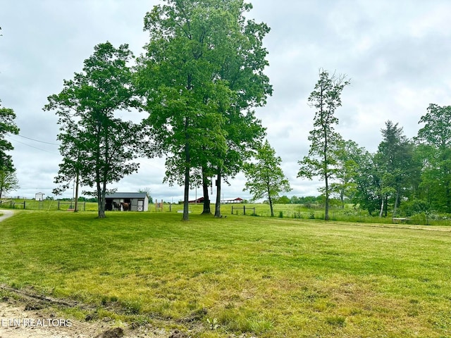 surrounding community featuring a rural view and a yard