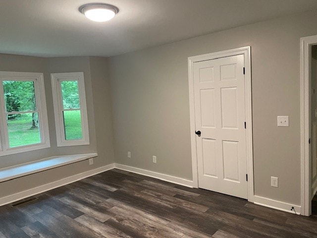 empty room featuring dark wood-type flooring