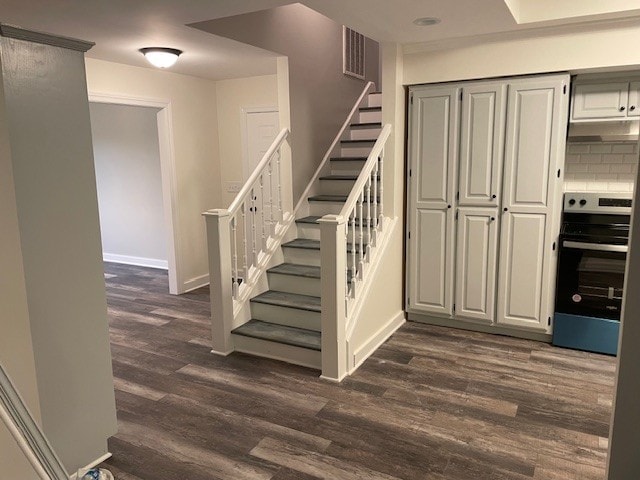 staircase featuring wood-type flooring