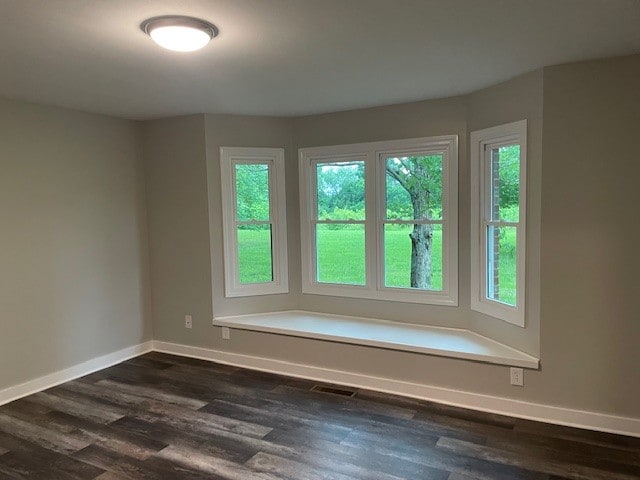 unfurnished room featuring dark hardwood / wood-style floors