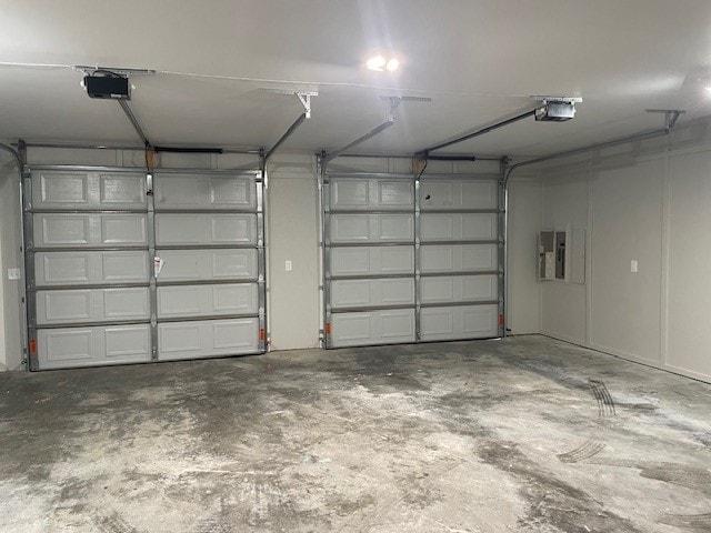 garage featuring a garage door opener and electric panel