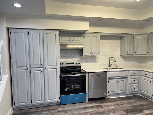 kitchen with dark hardwood / wood-style flooring, sink, backsplash, electric range, and stainless steel dishwasher