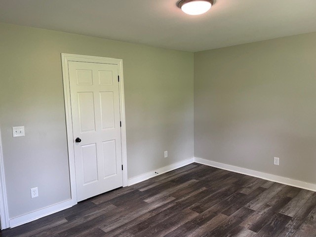 empty room featuring dark hardwood / wood-style floors