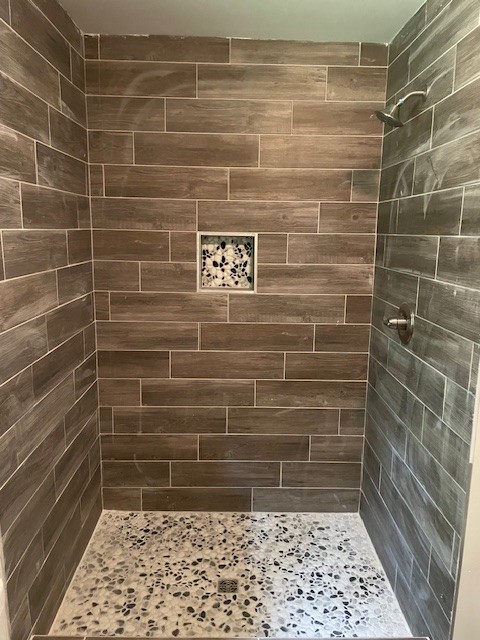 bathroom with a tile shower