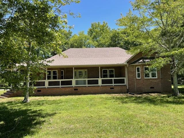 view of front of house featuring a sunroom and a front yard