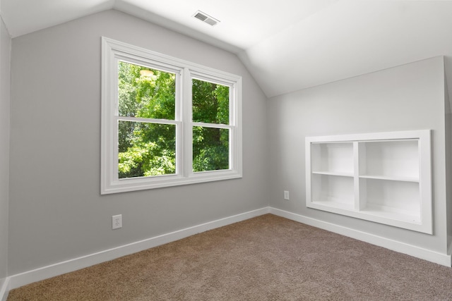 bonus room featuring carpet, built in features, and vaulted ceiling