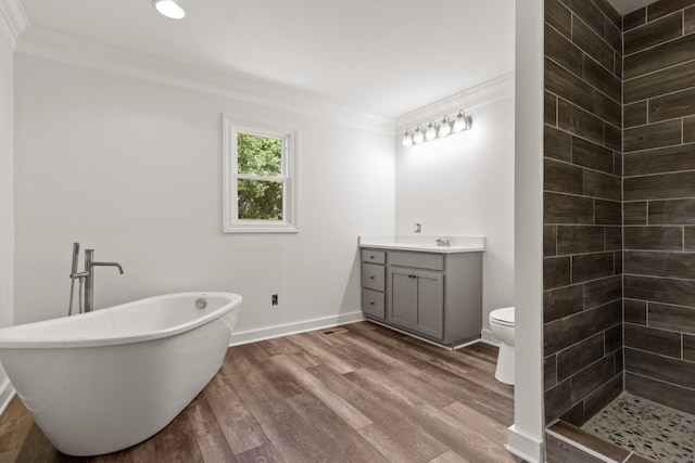 full bathroom featuring toilet, vanity, wood-type flooring, and ornamental molding