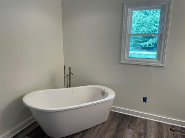 bathroom featuring a bathtub and hardwood / wood-style floors