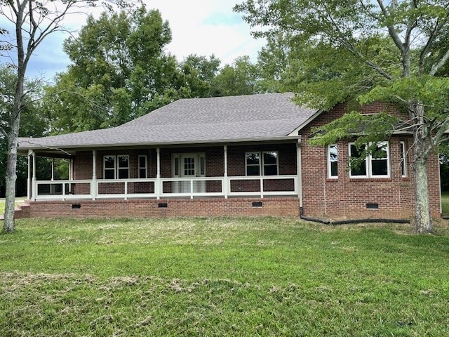 back of property featuring a yard