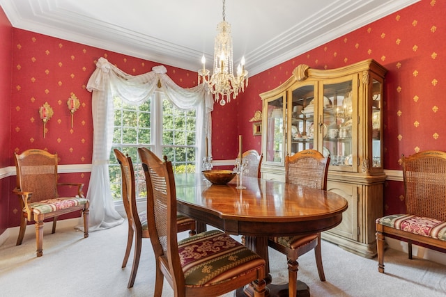 carpeted dining room with a chandelier and ornamental molding