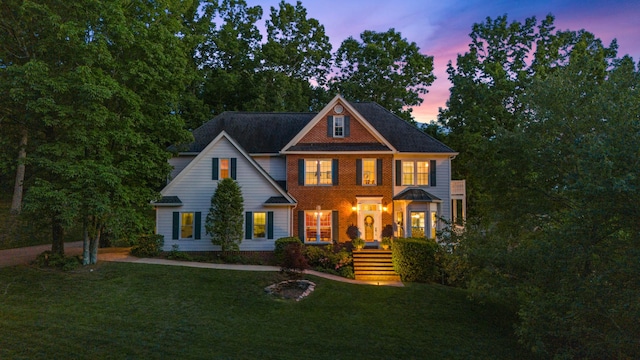 colonial inspired home featuring a lawn