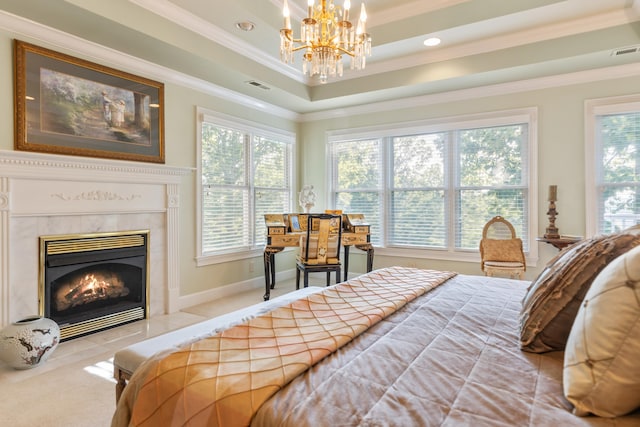 carpeted bedroom with ornamental molding, a tiled fireplace, multiple windows, and a raised ceiling