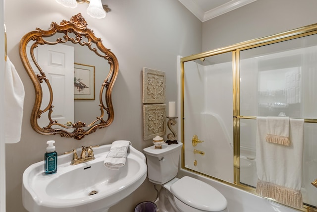 full bathroom with sink, shower / bath combination with glass door, toilet, and ornamental molding