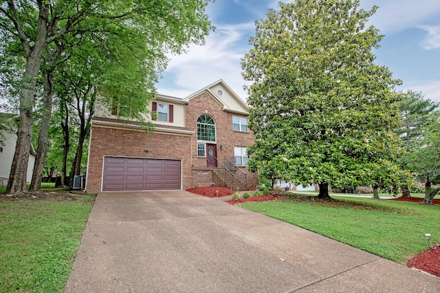 view of front of property with a garage and a front lawn