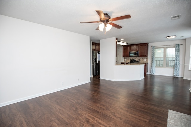 unfurnished living room with sink, dark hardwood / wood-style flooring, ceiling fan, and a textured ceiling