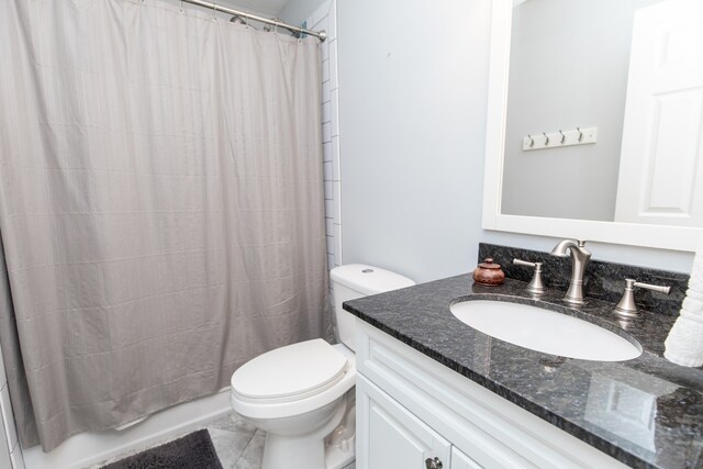 bathroom featuring vanity, toilet, and tile floors