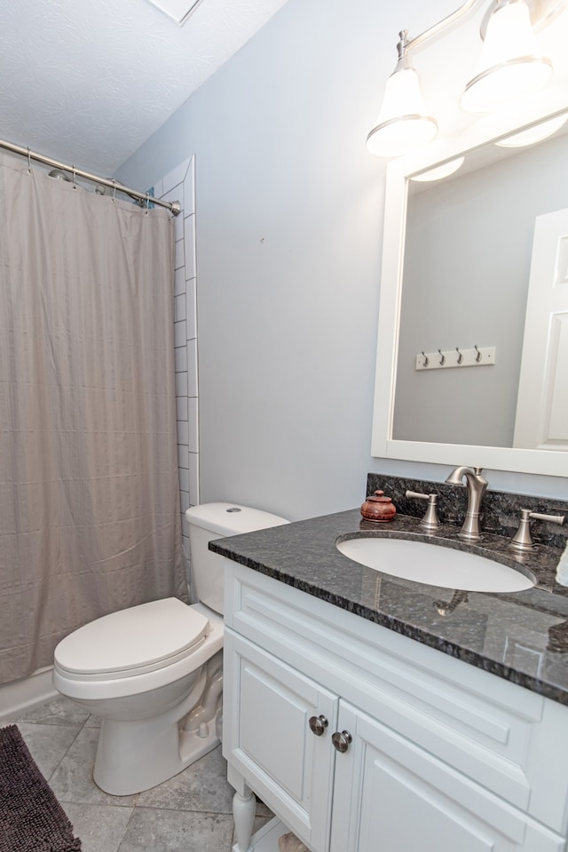 bathroom featuring tile floors, toilet, and vanity