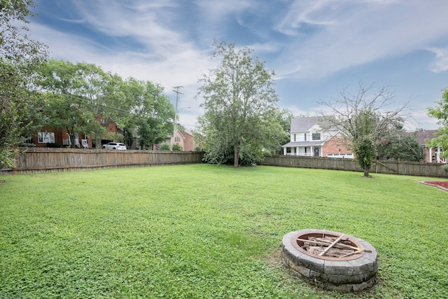 view of yard featuring an outdoor fire pit