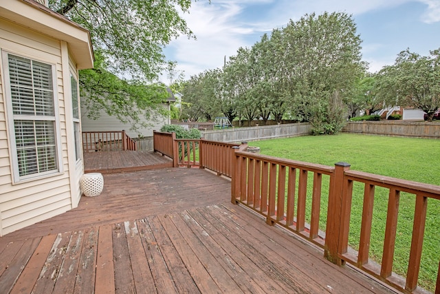 wooden deck featuring a lawn