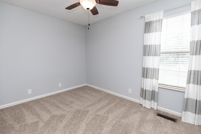 carpeted empty room with ceiling fan