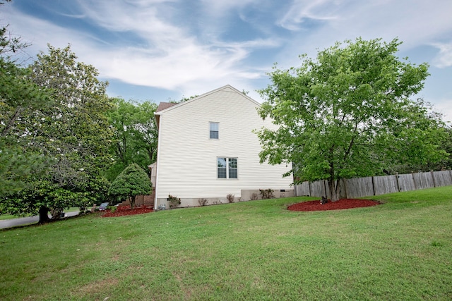 view of home's exterior with a yard