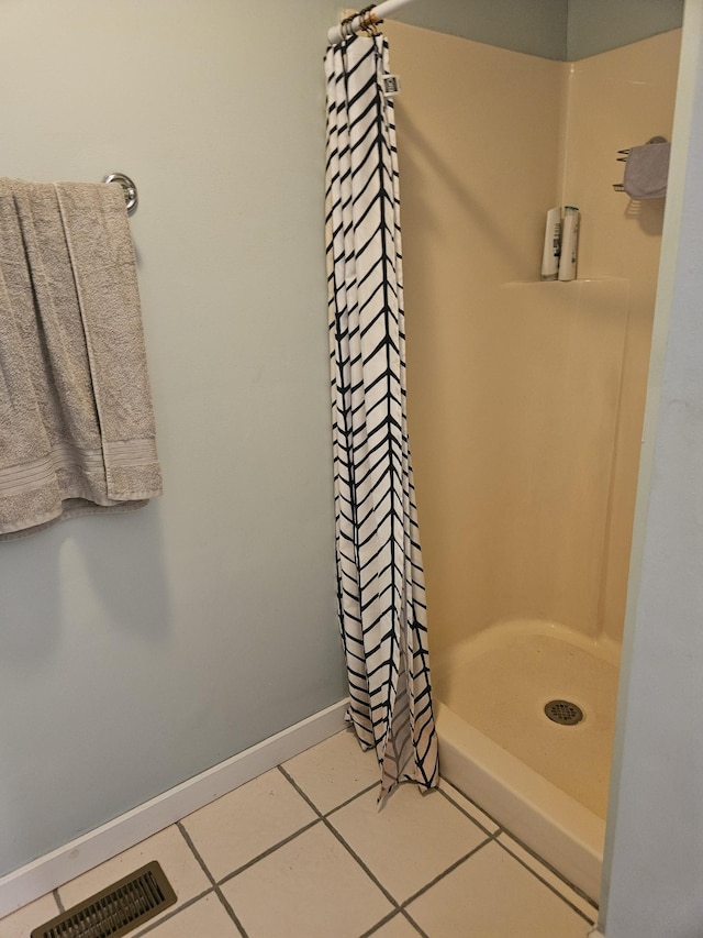 full bath with visible vents, a shower stall, baseboards, and tile patterned floors