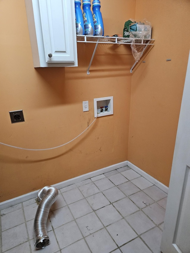 clothes washing area featuring electric dryer hookup, light tile patterned flooring, cabinets, and washer hookup