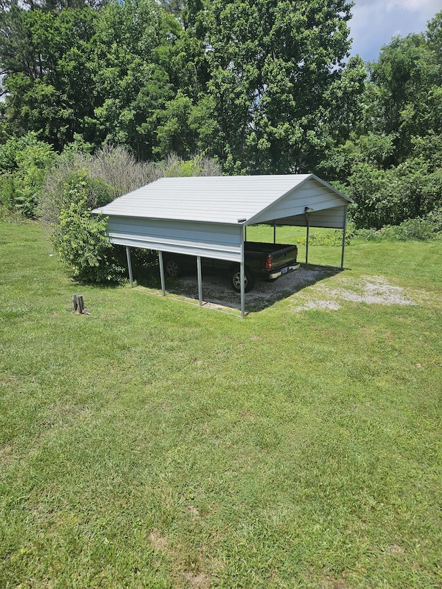 view of outbuilding featuring a carport and a lawn