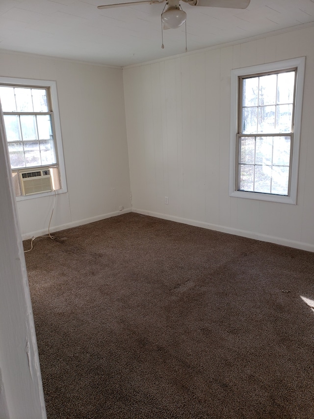 unfurnished room with ceiling fan and dark colored carpet