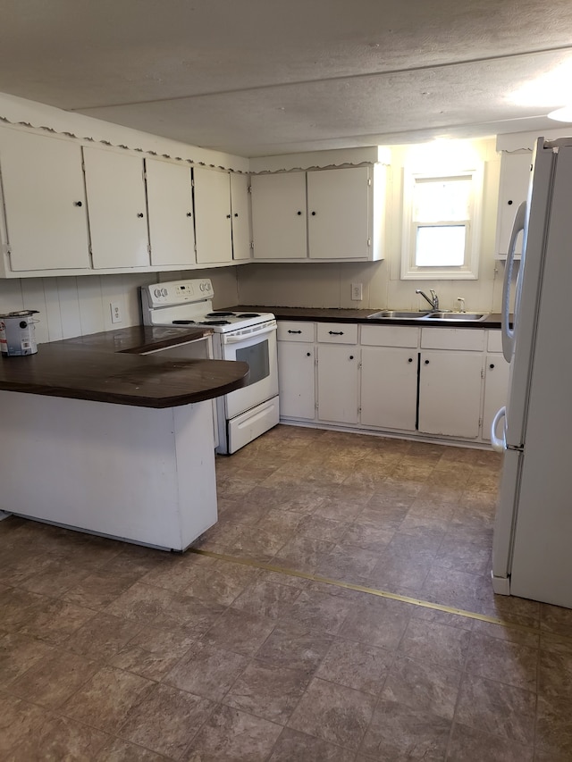 kitchen featuring kitchen peninsula, tile flooring, white cabinets, sink, and white appliances