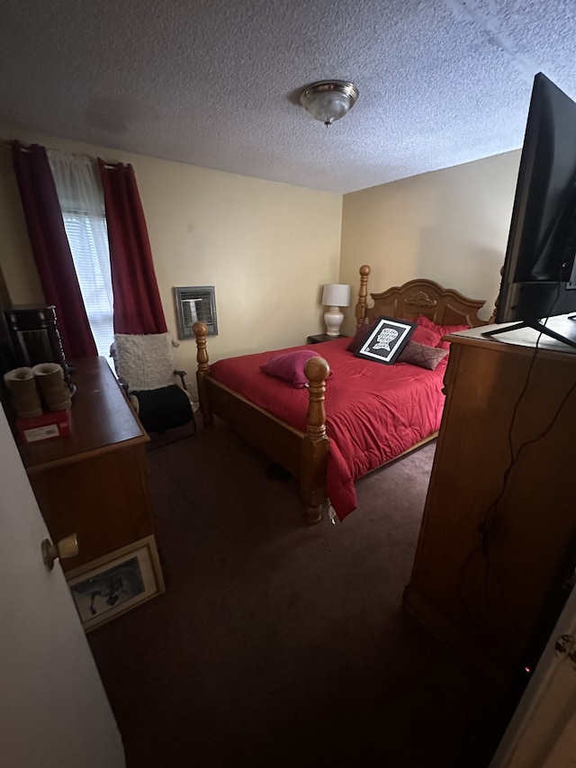 bedroom with a textured ceiling and carpet