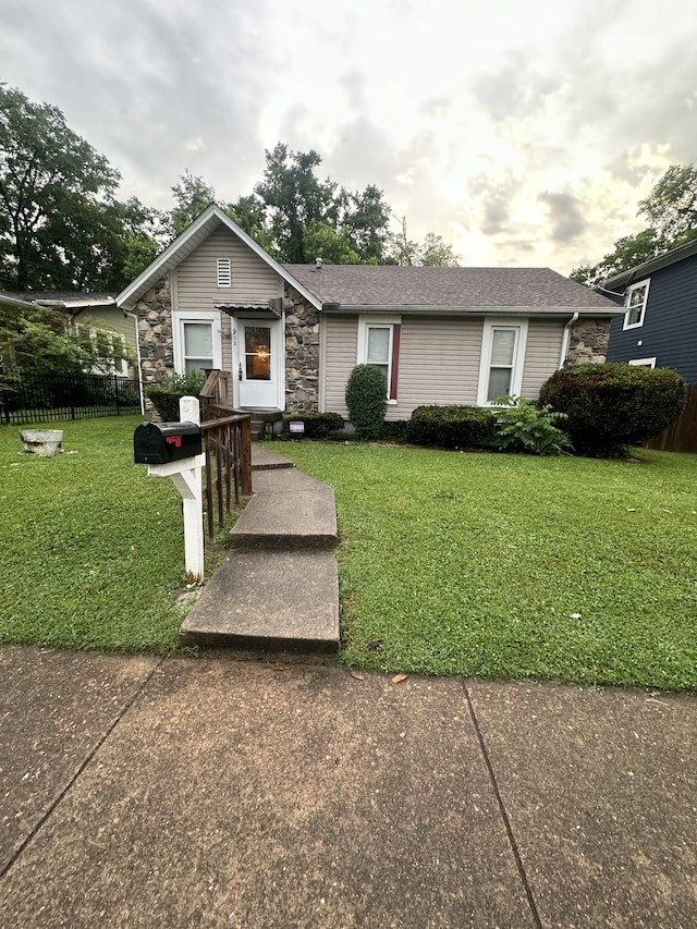 ranch-style home with a front lawn